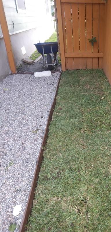Side-yard gravel walkway and edging installation in progress