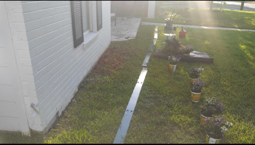 New flowering plants arranged beside a home before installation